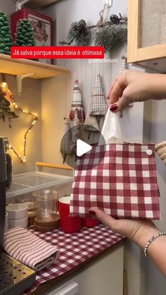 a woman is opening a bag in the kitchen