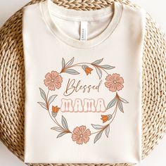 a white t - shirt with the words,'blessed mama'printed on it