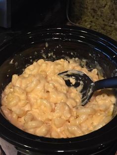 a black crock pot filled with oatmeal