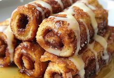 cinnamon rolls are piled on top of each other and drizzled with icing