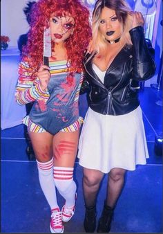 two women dressed up in costumes posing for the camera, one holding a knife and the other wearing tight stockings