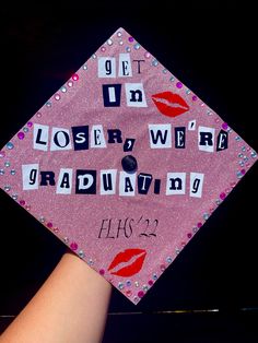 a pink graduation cap with words written on it