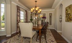 a dinning room table with chairs and chandelier