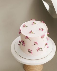 a white cake with pink flowers on it