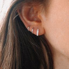 a close up of a person's ear with two small rings on the side