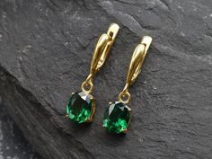 Gold Emerald Earrings set with a Created Emerald in a flawless diamond cut & clarity, deep green color, at 10x8mm, 6 Carats a pair. Dangling Earrings made of Gold Vermeil ☞ thickest 18k Gold Plating on Solid 925 Sterling Silver ☞ made to last. Click here for ☞ Matching RingClick here for ☞ Matching Pendant Details:♥ Created Emerald in a flawless clarity and deep green color,♥ Garnet: 10x8mm, 3 Ct, Diamond cut♥ Lever Back Closure - "English Lock"♥ Height 17mm, Width 8mm♥ 18k Gold VermeilSKU 2828( Classic Green Diamond Cut Earrings, Emerald Earrings With Diamond Cut For Gift, Emerald Diamond Cut Earrings Gift, Formal Green Diamond Cut Earrings, Green Teardrop Earrings With Prong Setting, Elegant Green Diamond Cut Earrings, Gold Emerald Earrings, Baguette Earring, Deep Green Color