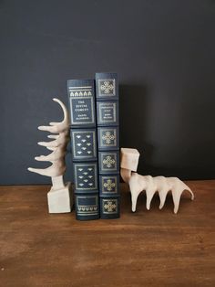 two bookends are sitting next to each other on a wooden table with books in front of them