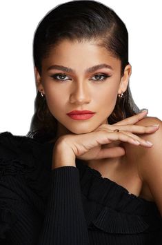 a woman with her hand on her chin, wearing a black top and red lipstick