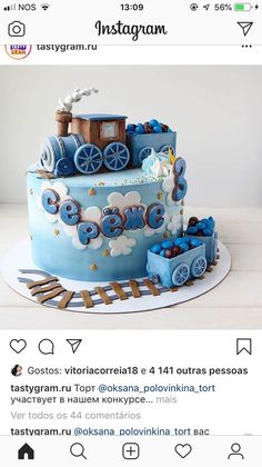 a blue train themed cake on top of a table