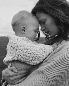 a woman holding a baby in her arms