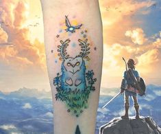 a person standing on top of a mountain next to a tattoo with an image of a deer