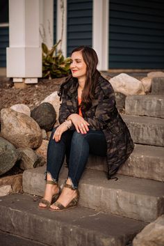 a woman sitting on steps in front of a house