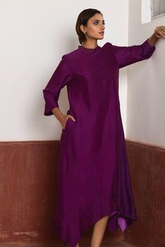 Purple dress with asymmetrical hem. Comes with purple Banarasi brocade jacket with woven floral patterns. - Aza Fashions Purple Silk Kurta For Party, Festive Long Sleeve Dresses For Workwear, Elegant Festive Dress With Set-in Sleeves, Elegant Purple Dress With Side Slits, Fitted Silk Purple Kurta, Elegant Fitted Purple Kurta, Fitted Silk Straight Kurta Dress, Elegant Silk Kurta For Work, Silk Dress With Asymmetrical Hem For Festive Occasions