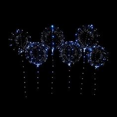 some blue and white lights on a black background in the dark with stars all over it