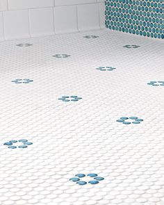 a bathroom with blue and white tiles on the floor