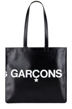 Find COMME DES GARÇONS Huge Logo Tote Bag on Editorialist. COMME des GARCONS Huge Logo Tote Bag in Black Smooth cow leather with twill lining. Made in Spain. Double shoulder straps measures approx 25 in length with a 10 drop. Measures approx 14W x 13H x 0.25D. Interior zip pocket. Printed logo detail. Gold foil logo detail. CMEX-UY39. SA9001HL. About the designer: The often avant-garde and always influential label was created by Kawakubo in Tokyo in 1969 before heading to Paris in 1981 where it garnered both acclaim and controversy with a debut collection of distressed and deconstructed pieces. The modern Comme des Garçons brand, which encompasses anentire family of sub-brands in fashion and fragrance, is worn by men and women who like to take an esoteric style stance. Gold Foil Logo, Logo Tote Bag, Black Tote Bag, Print Logo, Cow Leather, Gold Foil, Shoulder Straps, Zip Pockets, Foil