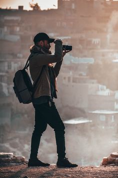 a man with a backpack and camera taking pictures