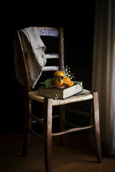 a wooden chair with some fruit on top of it