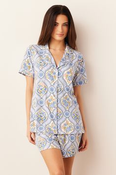 The Maren PJ Set is a traditional-style sleepwear ensemble featuring charming piping detail along the collar and sleeves. Paired with loose fit shorts with pockets, it offers a comfortable and stylish option for a good night's sleep. Product Details: Short sleeve top with notch collar Piping detail Fabric covered buttons Inseam is 2 1/2" Loose fit short with pockets Elastic waistband Polyester/Spandex knit, double brushed for ultimate softness Model is 5'8" and is wearing a size Small Boyfriend Shirt, Fabric Covered Button, Notch Collar, Notched Collar, Pj Sets, Shorts With Pockets, Fabric Covered, Covered Buttons, Good Night Sleep