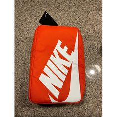 Nike Shoebox Orange Bag New Top Handle 13 Inches Height 8 Inches Width 100% Polyester Functional Orange Pouch Bag, Functional Orange Rectangular Bag, Functional Orange Rectangular Bags, Daily Use Logo Pouch Bag, Functional Orange Sports Bag, Casual Orange Sports Bag, Nike White Everyday Bags, Functional White Bag With Logo, Functional White Bags With Logo