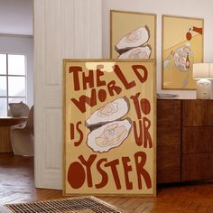 there is a poster on the wall in the living room that says, the world is your oyster