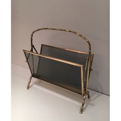 a metal frame holding a mirror on top of a table