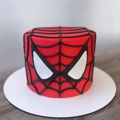 a spiderman cake is sitting on a plate