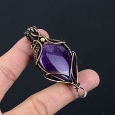 Handmade Copper Chain Size 18-20Inch - https://www.etsy.com/in-en/listing/1162990726 Welcome to our little shop, where you can find handmade copper wire jewelry and more, for you and your loved ones. We do accept custom orders also, kindly message us for more. Amethyst Gemstone Copper Wire Wrapped Handmade Pendant Gemstone : Amethyst  Pendant Length : 7.2 CM Metal : Copper  * Protection:- Copper will be tarnished after a while so try to limit contact with lotions, soaps or anything moist and never wear it in the shower, swimming or anywhere else it may come in contact with water. If tarnish becomes an issue, you may clean this item with jewelry cleaning cloth or ultra polishing pads. * Packing:- Your jewelry arrived in a beautiful gift box stored in bubble wrap for safe travel. * Rush your Purple Amethyst Pendant Crystal Necklace, Amethyst Pendant For Jewelry Making, Amethyst Crystal Necklaces For Jewelry Making, Purple Pendant Crystal Necklace With Stones, Purple Crystal Pendant Necklace With Stones, Purple Crystal Pendant Necklace, Purple Gemstone Amulet Necklace, Purple Amethyst Amulet Necklaces, Purple Amethyst Crystal Necklace In Mystical Style