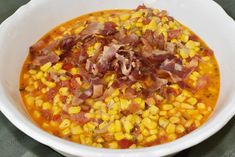 a white bowl filled with corn and bacon