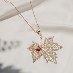 Quirky and stylish fall jewelry for you! Beautiful dainty Gold Maple Leaf Pendant with cubic zircons and enameled red ladybug on the pendant. The necklace is long and adjustable. All of our jewelry is hypoallergenic and suits all skin type. Details: Brass metal Gold Plated Hypoallergenic Boho Necklace Ladybug - Maple Leaf (Pendant) Cubic Zirconia Stones *Care: Do not use perfumes or sanitizers around or on the jewelry. Clean it with a cotton cloth. Gold Plated Leaf-shaped Jewelry For Gifts, Leaf Shaped Metal Jewelry For Gifts, Leaf-shaped Metal Jewelry For Gifts, Leaf-shaped Metal Jewelry As Gift, Metal Leaf-shaped Jewelry For Gifts, Leaf-shaped Metal Jewelry Gift, Metal Leaf-shaped Jewelry Gift, Elegant Red Necklace With Charms, Leaf-shaped Jewelry For Gift