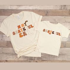 "fall vibes,hello fall shirt,pumpkin spice shirt,fall season shirt,fall vibes shirt,pumpkin sweatshirt,kids thanksgiving,girl turkey shirt,baby thanksgiving,boys thanksgiving,grateful shirt,girl thanksgiving,kids fall shirt,family shirt,matching shirts,family shirts,mama shirt,baby shower gift,new mom gift,mom shirt,mommy and me shirt,mama and mini shirt. Introducing our latest mommy and me shirts! These cute and funny shirts feature witty definitions of \"mama\" and \"mini\" that are sure to ma Mom And Me Shirts, Grateful Shirt, Mom Of Boys Shirt, Pumpkin Spice Shirt, Turkey Shirts, Mommy And Me Shirt, Family Shirts Matching, Mom Life Shirt, Matching Tees