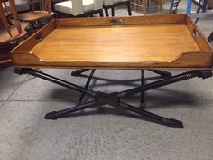 a wooden tray sitting on top of a metal stand