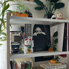 a book shelf filled with books and plants