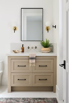 a bathroom with a sink, mirror and rug on the floor in front of it