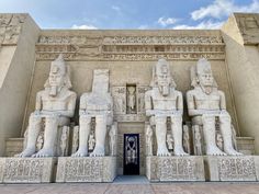 the entrance to an egyptian temple with statues