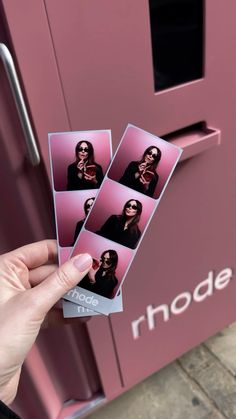 a person holding up some pink polaroid pictures