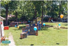 an outdoor play area is decorated with balloons