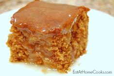 a close up of a piece of cake with icing on a white plate,