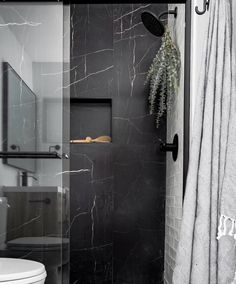 a bathroom with black and white marble walls