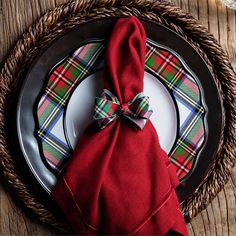 a red napkin with a bow sits on a plate