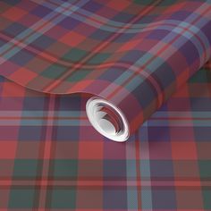 a red, blue and green plaid wallpaper with a white circle on the center