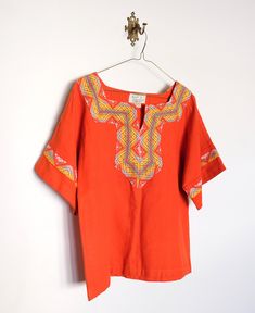 Beautifully hand embroidered and SO FUN for spring/summer with a 70s vibe Square neckline with slight V in middle Best fits Women's small/medium Summer Orange Embroidered Blouse, Festival-style Orange Embroidered Tops, Orange Floral Embroidered Cotton Top, Embroidered Orange V-neck Tops, Red Bohemian Embroidered V-neck Top, Womens Tunics, Hand Embroidered, Bell Sleeve Top, Womens Clothing Tops