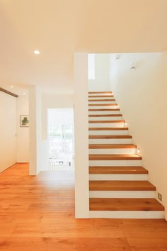 the stairs are made of wood and have led lights on them in this modern house