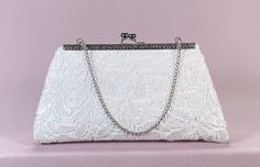 "This is a beautiful bridal lace clutch bag. It is perfect for the upcoming wedding season. It has been carefully made with high quality materials. Perfect accessory to compliment a range of outfits. It is large enough to hold your essentials (phone, keys, money/cards and lip stick. Designed from high end sequins lace fabric over off white satin and lined in white satin lining with one pocket inside. The interlining and interfacing used, help the bag hold its structure and maintain its shape rea Lace Clutch, Hamper Ideas, Bridesmaid Clutch, Bridal Clutch Bag, Bridesmaid Clutches, Bridal Bag, Wedding Purse, Bridal Clutch, Money Cards