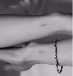 two hands holding each other with small tattoos on their wrists and the words vive are written in cursive font