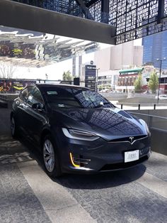 a black car parked in front of a building