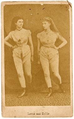 an old photo of two women in baseball uniforms, one with her hands on her hips