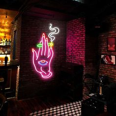 a neon sign that is on the side of a brick wall in a room with black and white checkered flooring