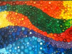 there are many different colored bubbles in the water and one is red, yellow, green, blue, orange