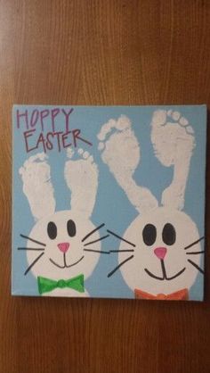 a painting of two white rabbits on a blue and green background with the words happy easter